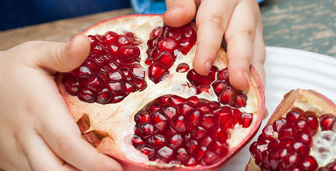 boy-eats-pomegranate