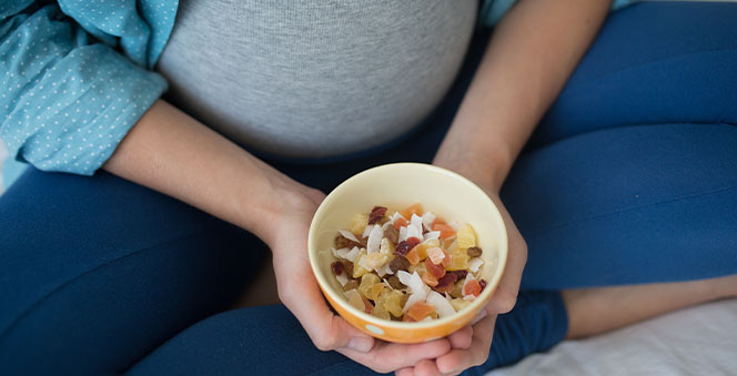 pregnant-woman-holding-small-plate-dried