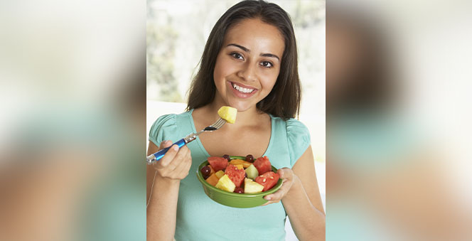 girl eating fresh fruit salad