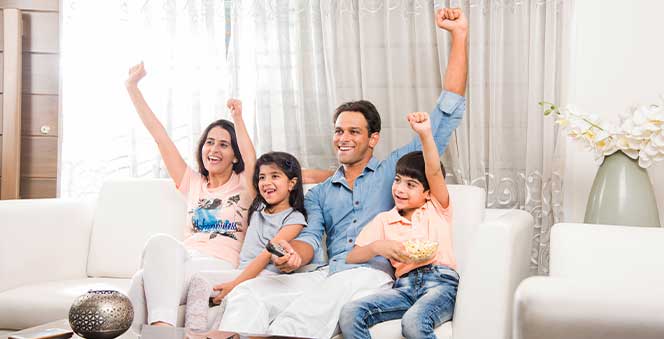 young family watching tv together